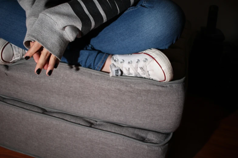 a woman resting her head on top of a bed