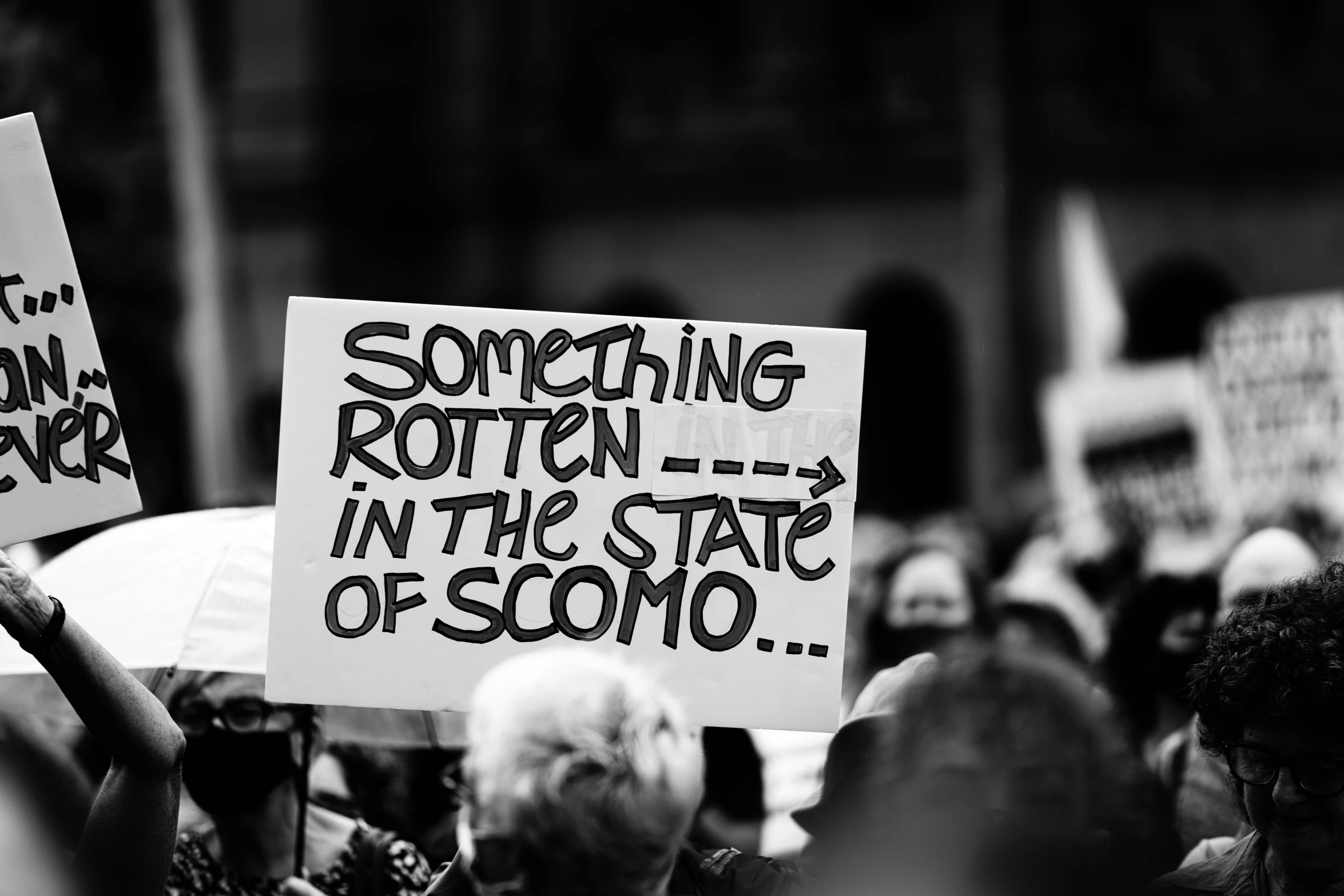 people holding up signs at a protest