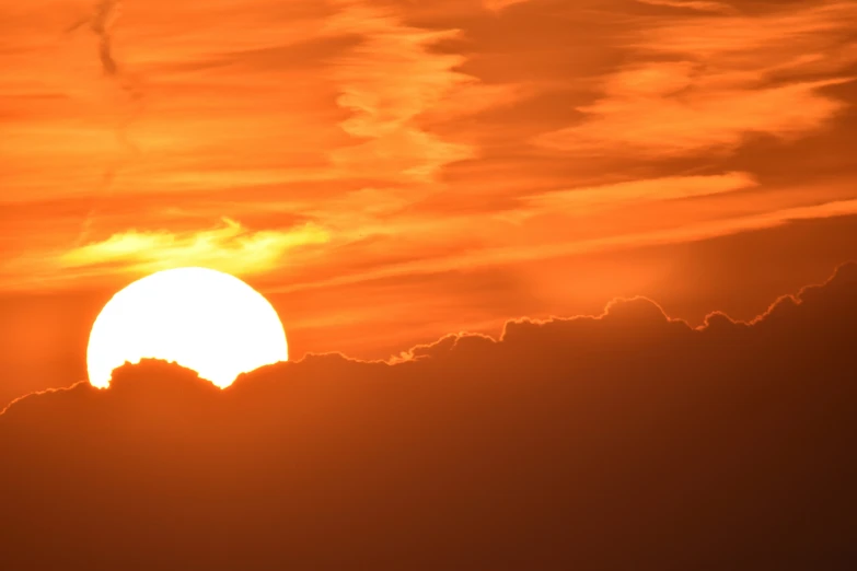 the sun is behind a big cloud covered sky