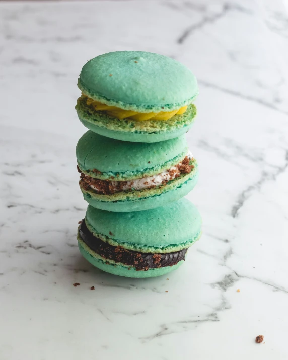 four macarons stacked next to each other on top of a counter