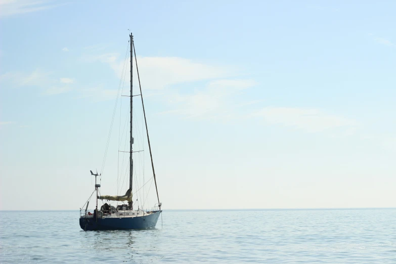 a small blue boat in the open ocean