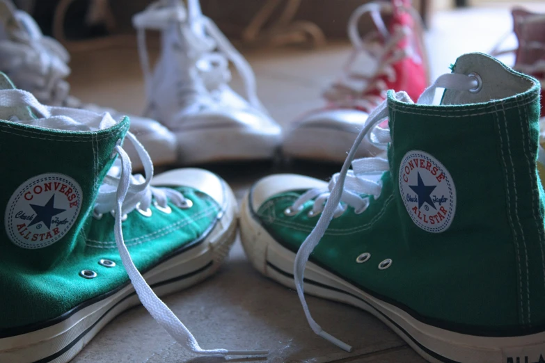 two converse shoes sitting next to each other