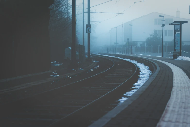 train tracks and street lights in the fog