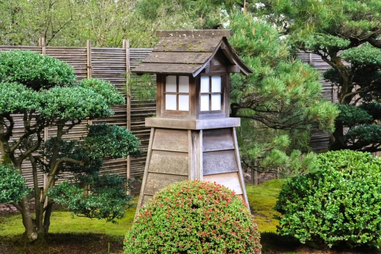 small wooden building sitting on top of a lush green field