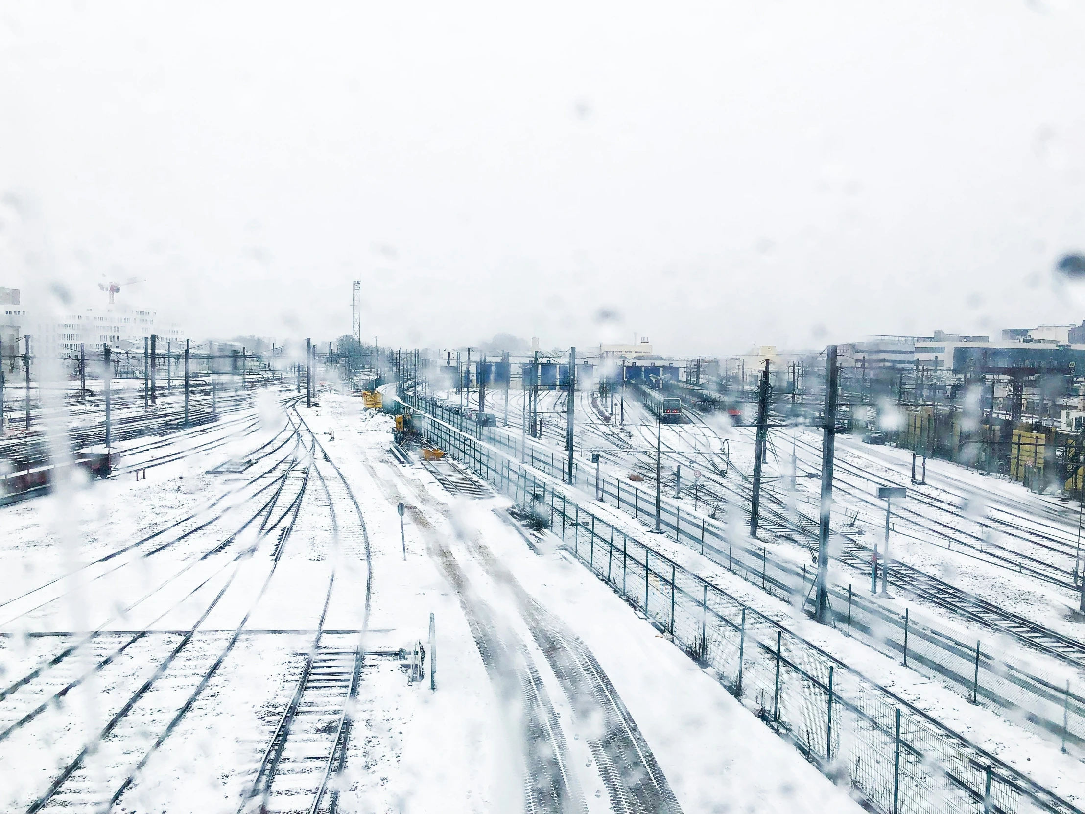 a train yard with tracks covered in snow