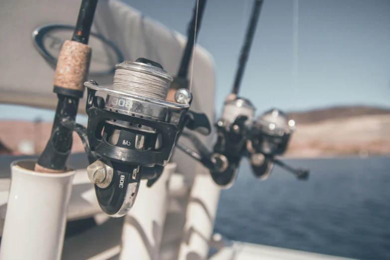 a number of spinning rods attached to the back of a boat