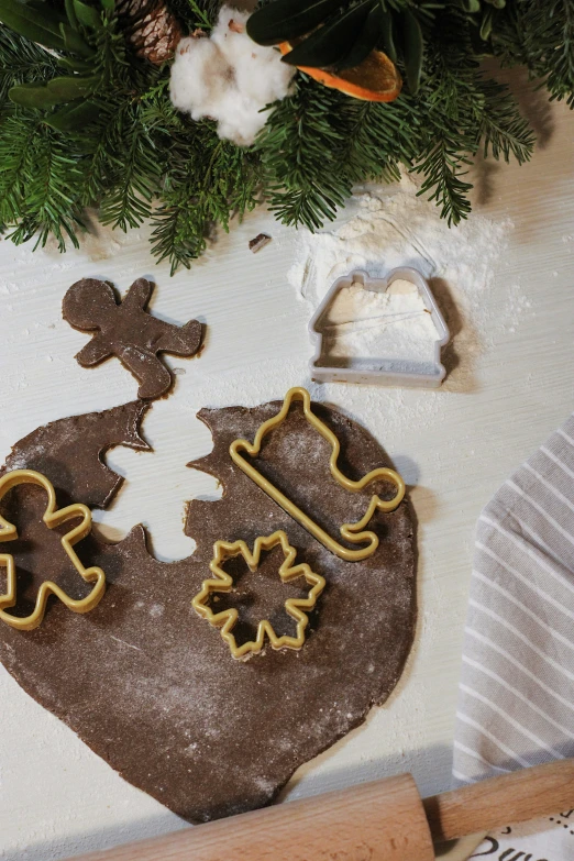 two cookies shaped like people holding a flag