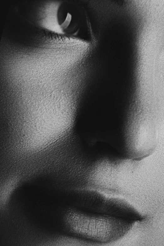 a closeup of a mans face and its shadow