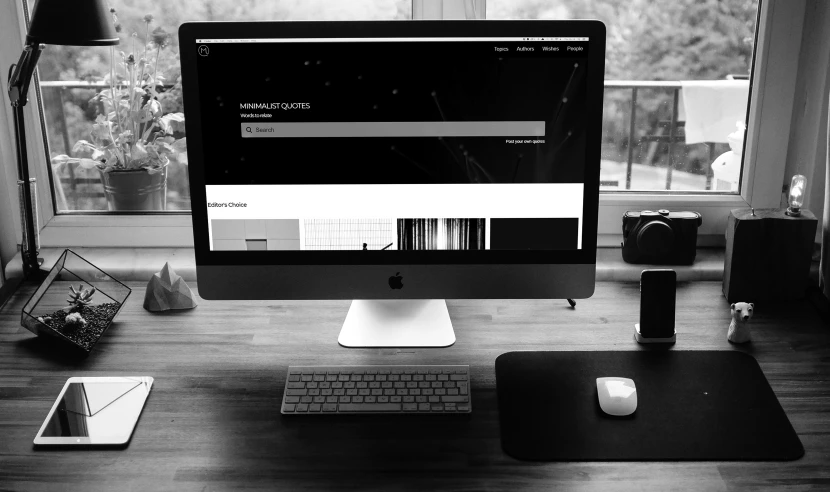 a computer screen is in the center of a work desk