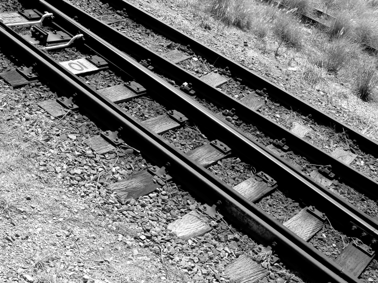 a black and white image of train tracks