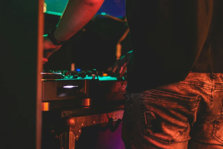 a man dj is playing in his sound studio