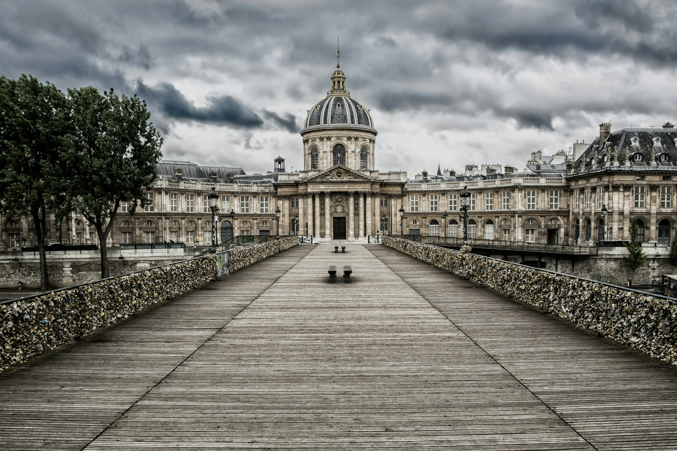 an old city walkway with a cathedral in the background