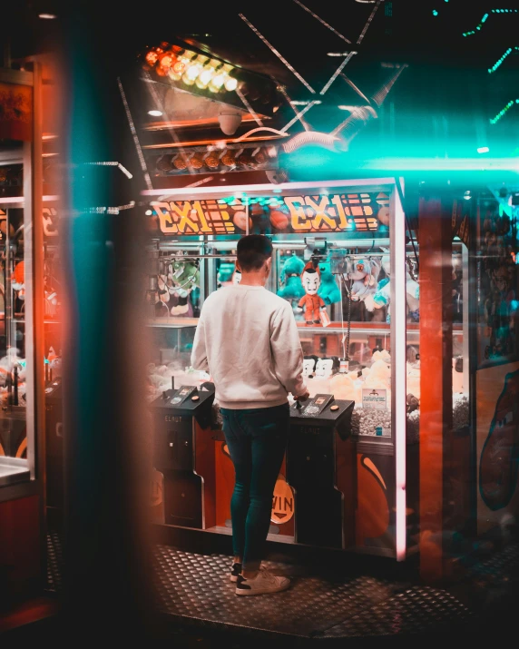 a man looks into a machine on the sidewalk