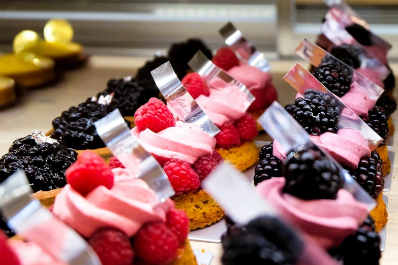 small pastries are decorated with raspberry and chocolate