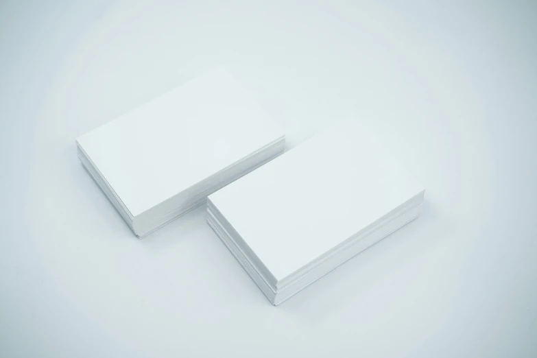 two white books with white paper on them