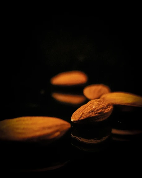 several chocolate cookies on black table, lit up with a soft glow