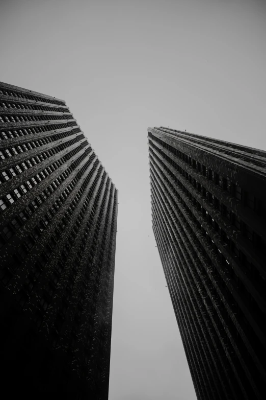 two buildings that are very tall with no tops