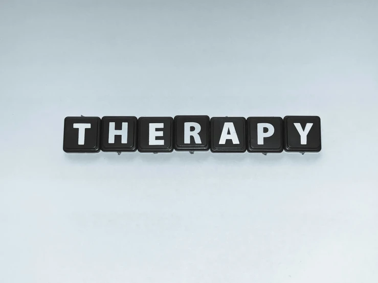 a word that says therapy over an image of black and white tiles