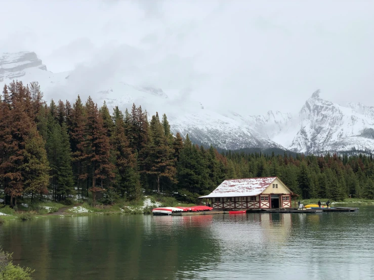 a lake with some boats and mountains in the background