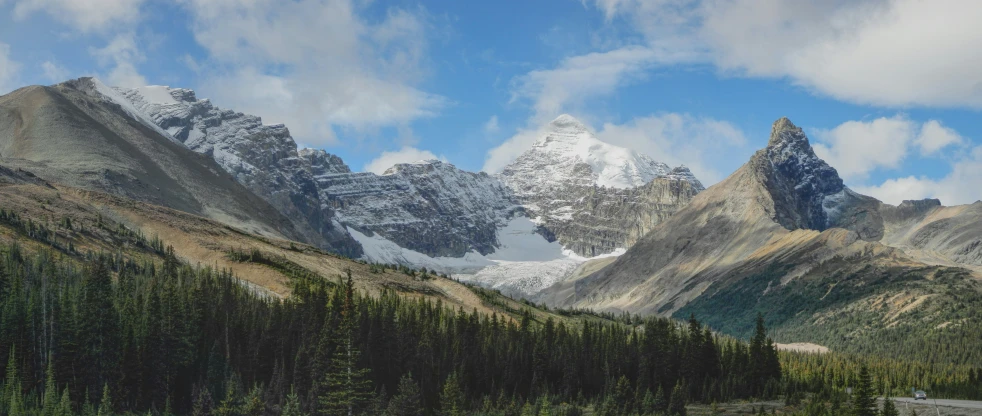 the road is next to the mountain peaks