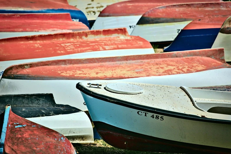 several different small boats sitting next to each other