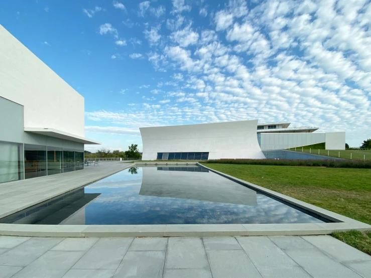 modern architecture and its reflection in the pool of water