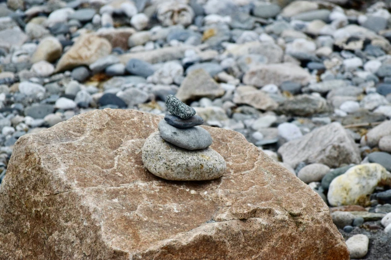 two rocks sit on a bed of rocks in the pebbles