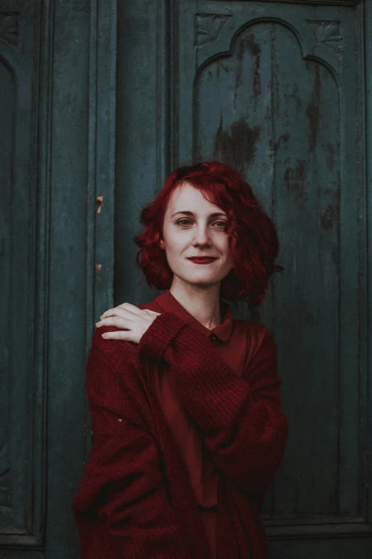 woman with red hair posing for a portrait