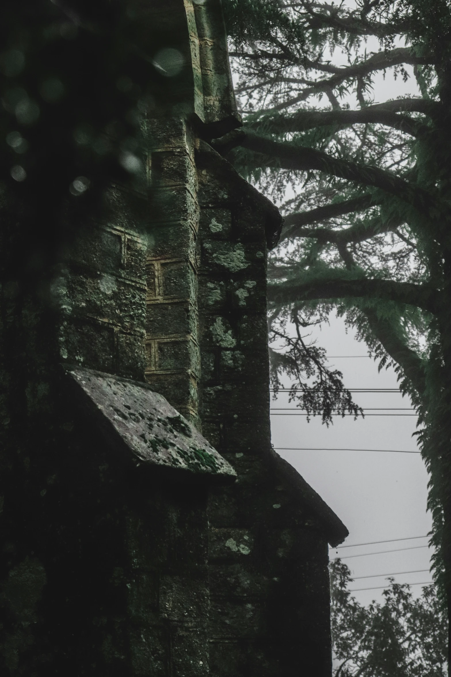 an old stone church with green trees in the background