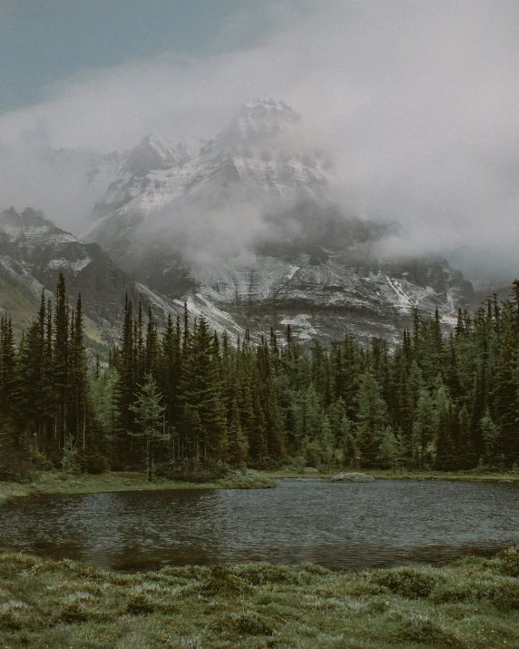 mountains rising up in the sky with snow on them