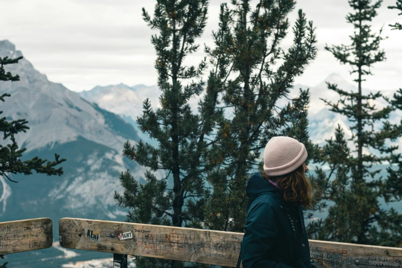 a person sitting on a bench with a view of a mountain