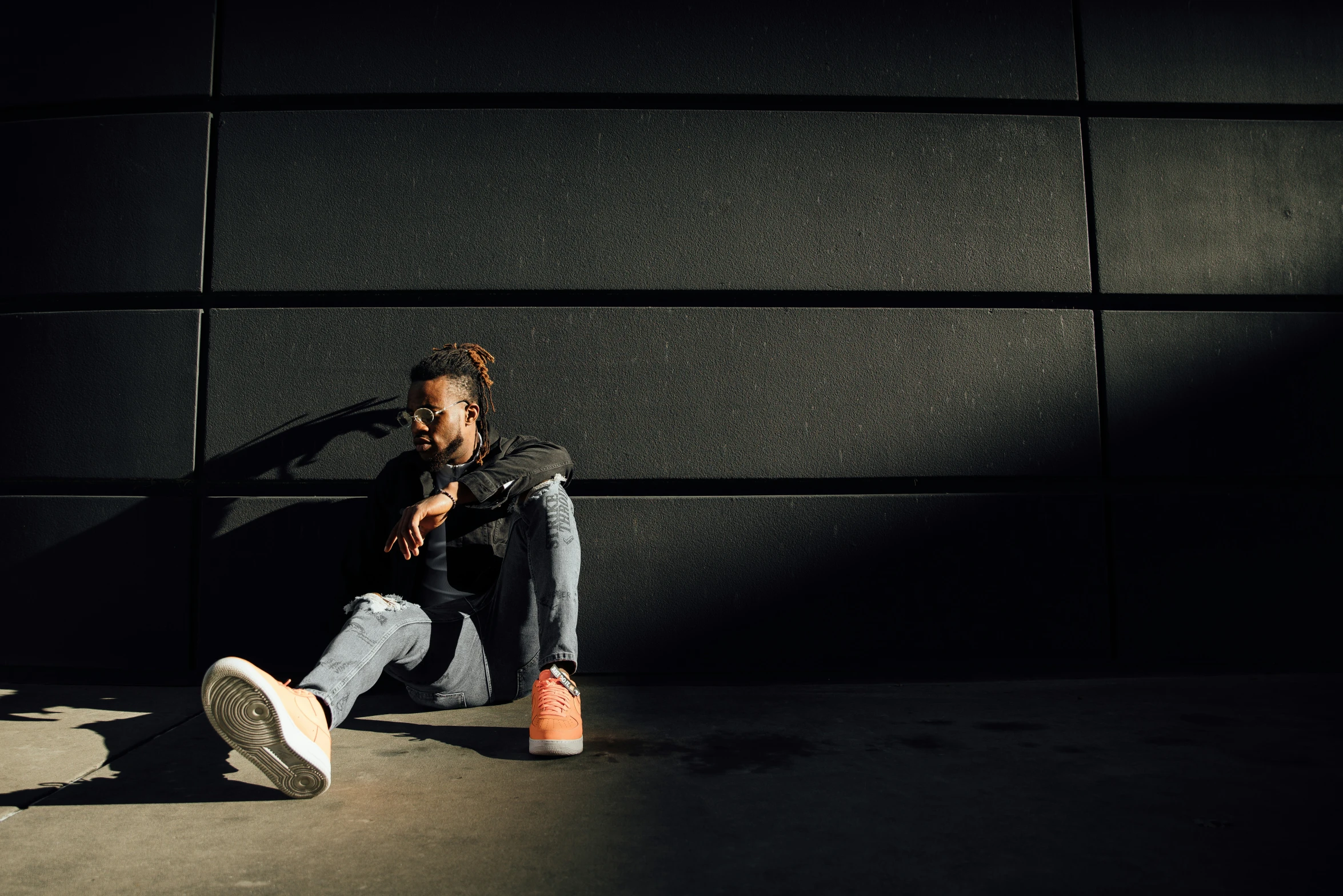 a person sitting on the ground with their legs crossed