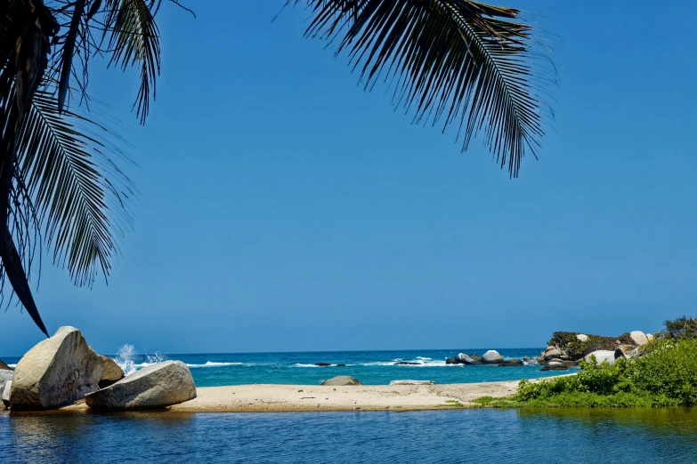 there is a large rock sitting on the beach