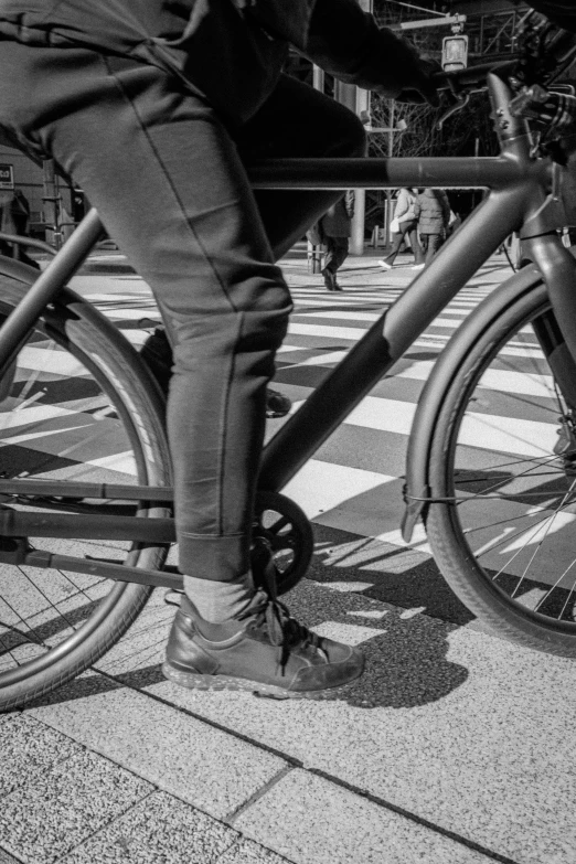 someone is standing on a bike in the street