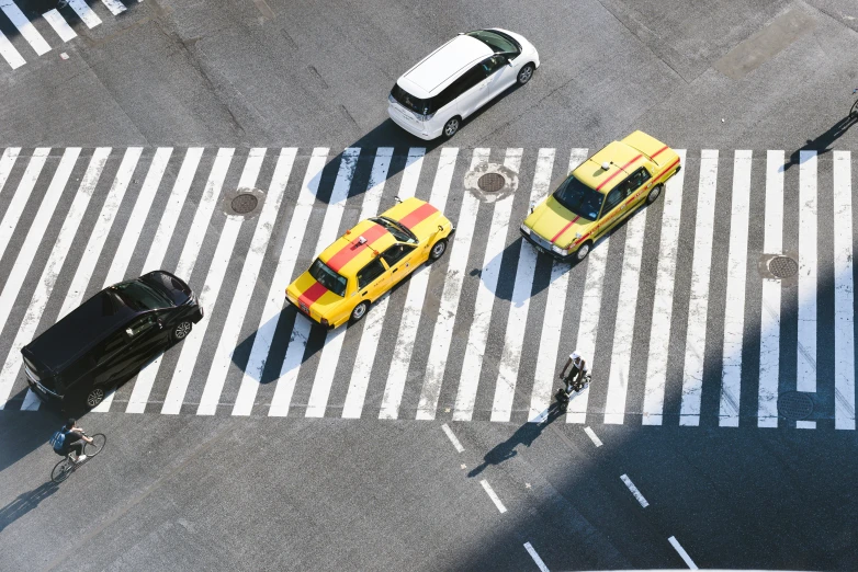 the overhead view of a ze crossing shows yellow cabs and white cars