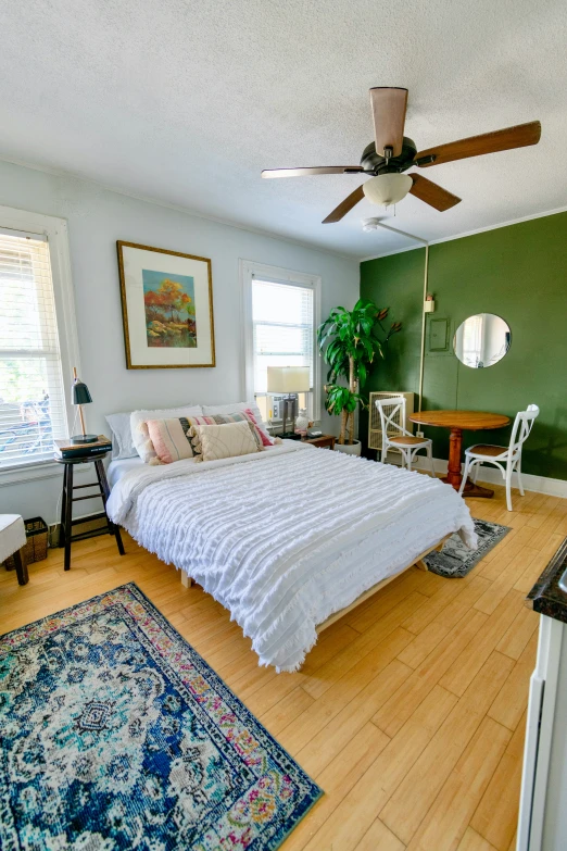 a bedroom with green walls, carpet and a bed