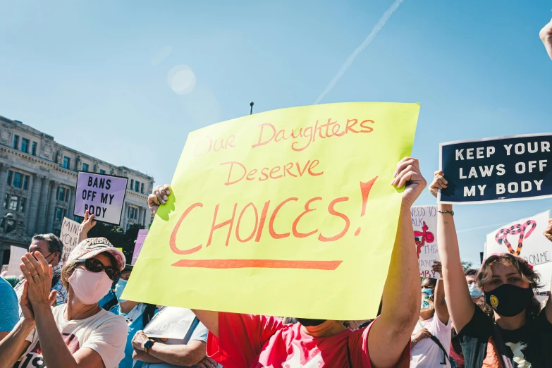 a protest with yellow signs in the middle