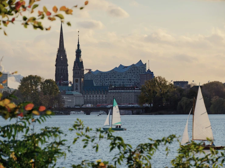 boats on water near city with church in background