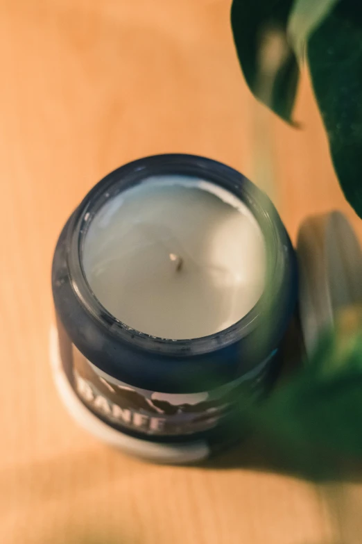 a small candle with a wooden surface