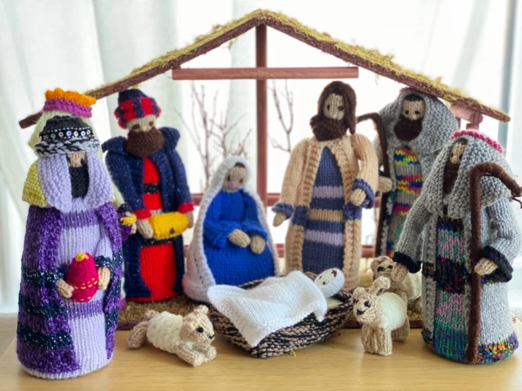 knitted nativity figurines with figures in front of him