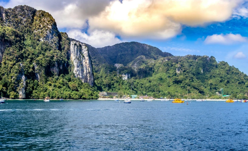 a lake surrounded by trees in front of a mountain