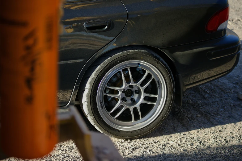 car tire sitting behind tree in parking lot