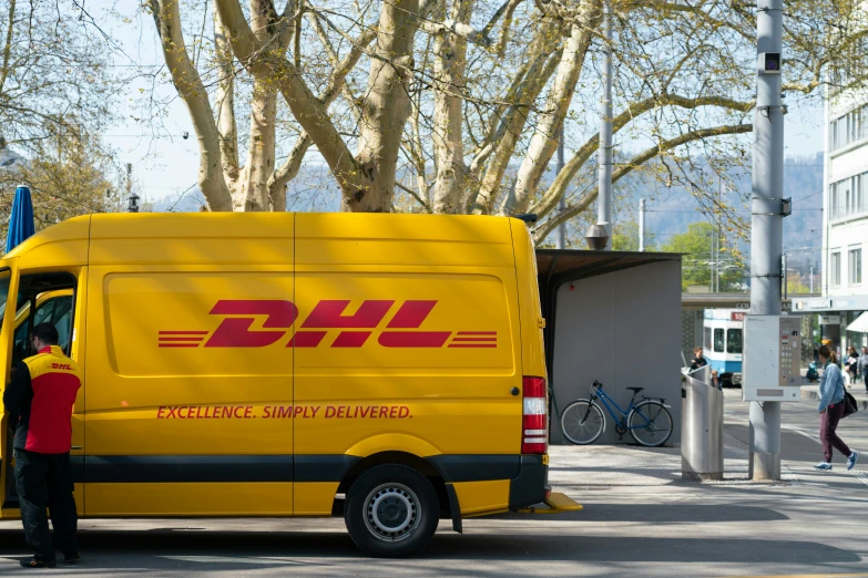 a dhl delivery truck parked in the street