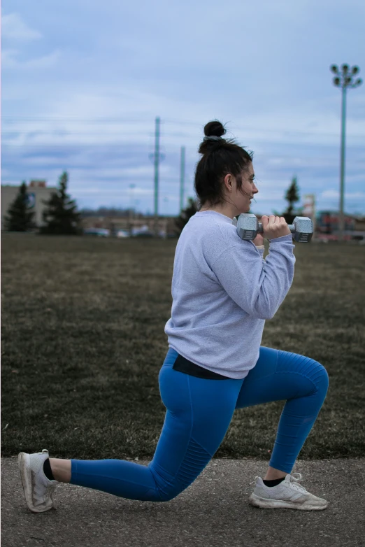 woman running while holding up two sports bottles