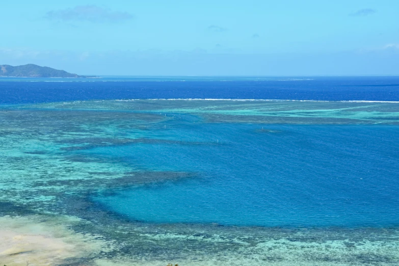 a couple of white boats floating on top of a blue ocean