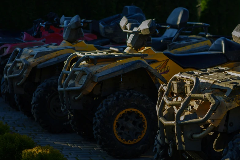 several large, three - wheeled vehicles are parked on the sidewalk