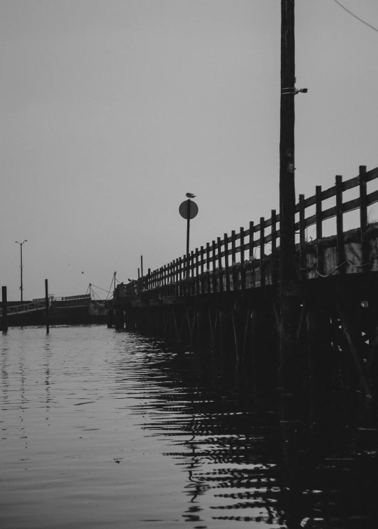 the pier is near some water and a street sign