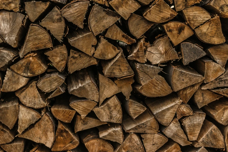 many different types of cut wood stacked together