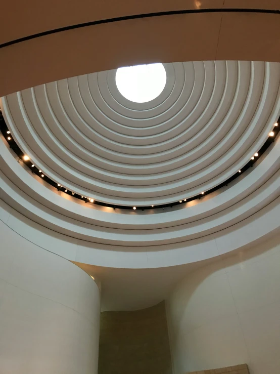 inside of a circular building with spirally lines of lights