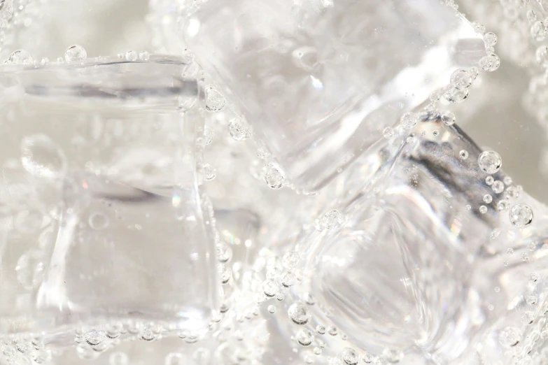 a group of small crystal cubes covered in water